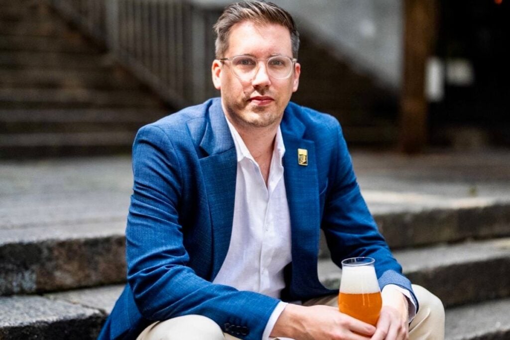 Hong Kong beer sommelier Andrew Munns sitting on Shin Hing Street